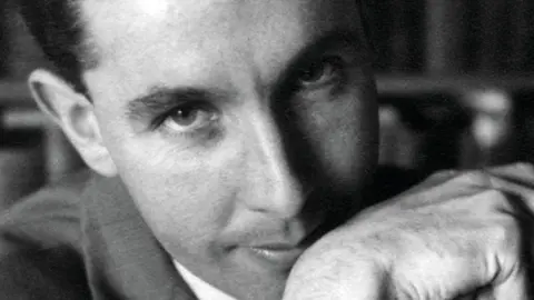 Essex Wildlife Trust Black and white image of Ronald Blythe wearing a shirt and jacket looking into the camera and resting his chin on his right wr ist