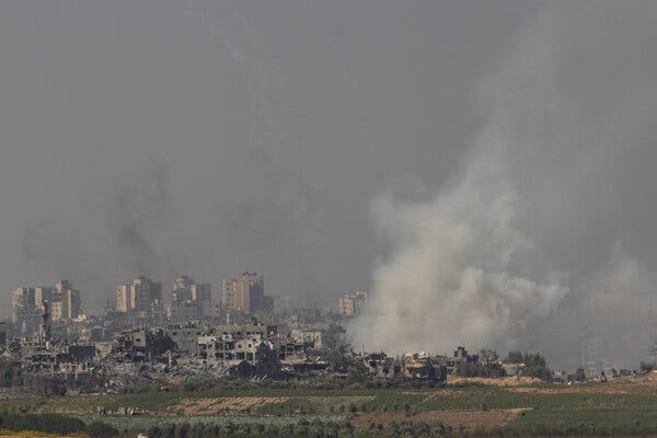 A collection of destroyed buildings with a cloud of smoke at the right.