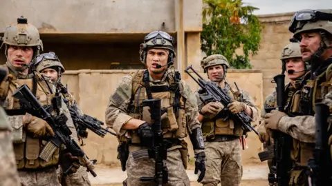 Murray Close Taylor John Smith, Charles Melton, Alex Brockdorff in army uniforms, holding guns