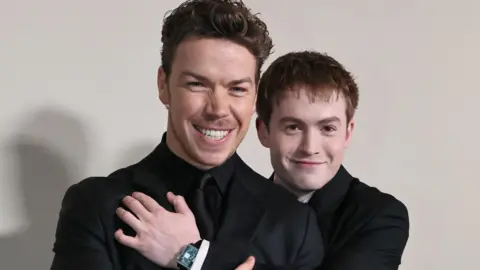 Getty Images Will Poulter and Kit Connor smiling and embracing