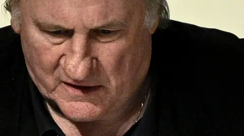 Getty Images French actor Gerard Depardieu looks on as he returns to the courtroom after a break on the fourth day of his trial in which he is charged with sexually assaulting two women during a film shoot in 2021, at the Paris criminal court in the Tribunal de Paris courthouse, on March 27, 2025.