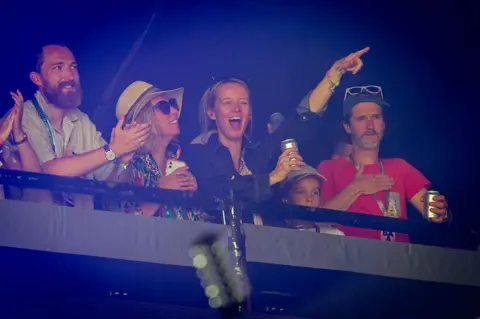 Getty Images Emily Eavis punches the sky as she watches CMAT perform on Glastonbury's Pyramid Stage