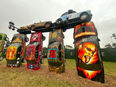 Glastonbury A Keith Flint mural is seen on one of the cars at Glastonbury's Carhenge monument