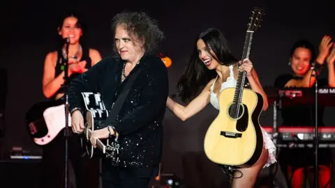 Getty Images Robert Smith playing guitar with Olivia Rodrigo