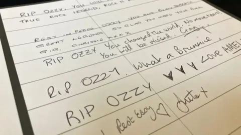 A page from the book showing several messages, most beginning "RIP Ozzy"