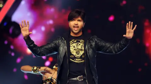 AFP via Getty Images Indian Bollywood actor Himesh Reshammiya performs at the 'Umang Mumbai Police Show 2017 in Mumbai on January 21, 2017