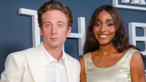 Getty Images Jeremy Allen White and Ayo Edebiri, both wearing white, attend a dinner for the cast and producers of The Bear at Musso & Frank Grill on June 9, 2025, in Hollywood, California