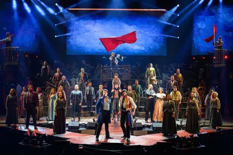 Getty Images Les Mis cast on stage in costumes, performing