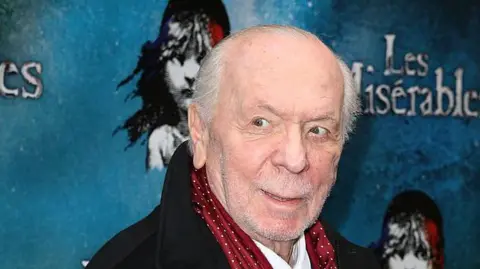 Getty Images Herbert Kretzmer in a coat and smart scarf at what looks like a Les Mis premiere