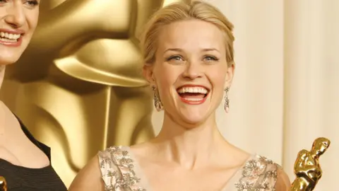 Getty Images Reese Witherspoon posing with an Oscar