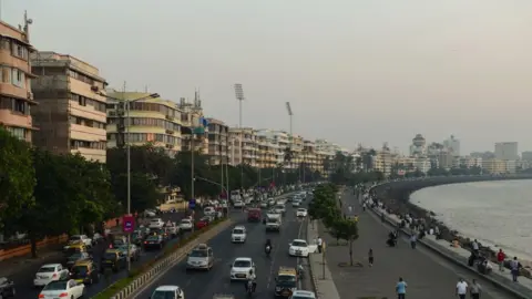 Getty Images A long-shot of Mumbai's Marine Drive corniche lined with Art Deco buildings overlooking the sea. 