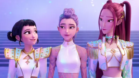 Netflix A still image showing the animated girlband from KPop Demon Hunters on stage