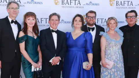 Getty Images The cast of Gavin and Stacey at the BAFTAs- Robert Wilfort, Melanie Walters, Rob Brydon, Ruth Jones, James Corden, Joanna Page and Mathew Horne Brydon wears a black suit, whit shirt and black bow tie. 